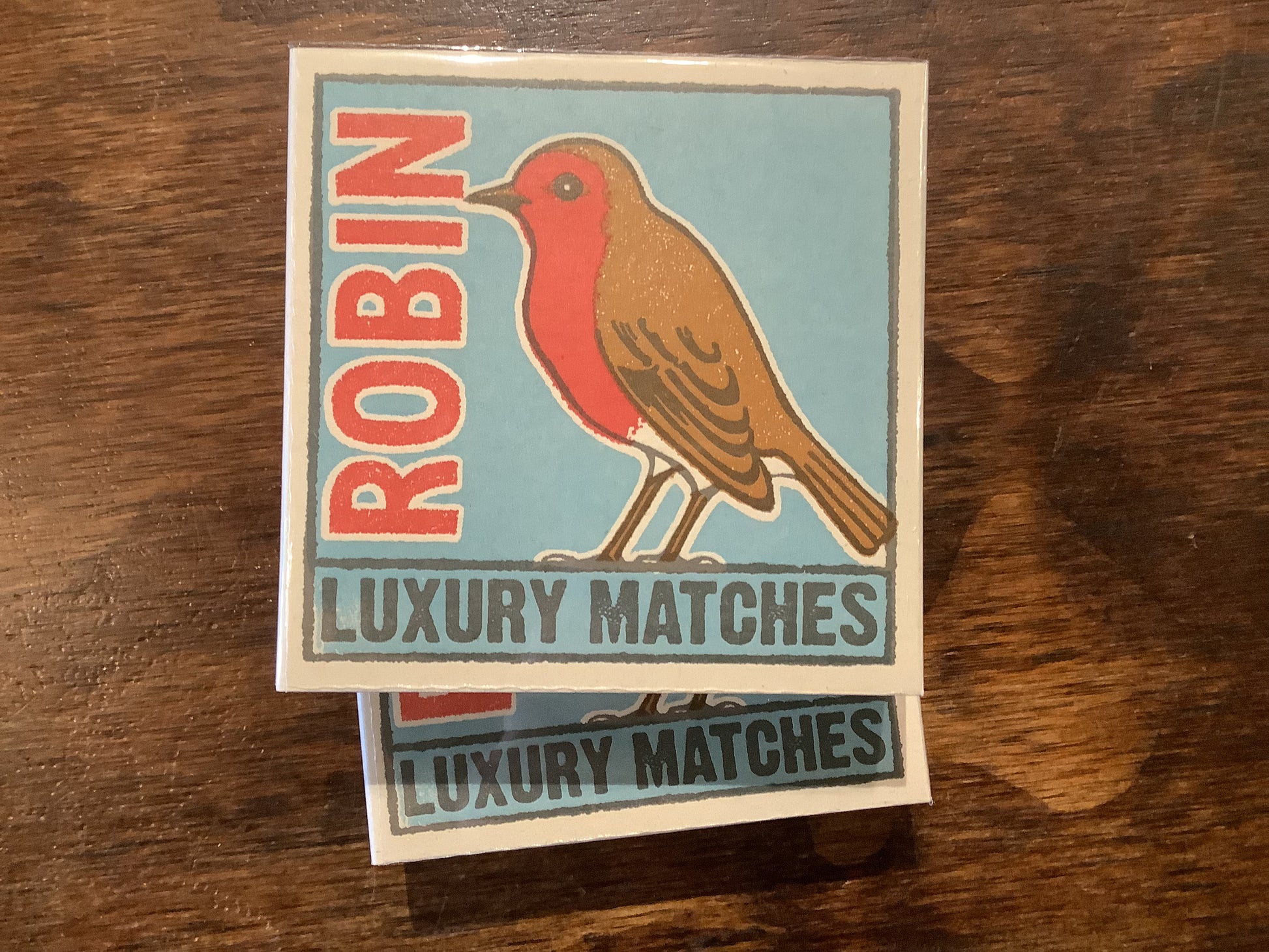 match box with a bird on it